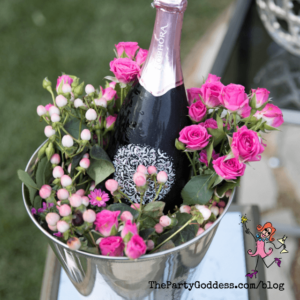 Nothing's Better Than A Springtime Pop Of Color - champagne in a silver bucket with pink roses