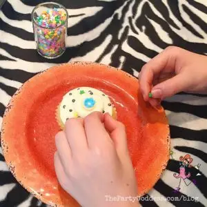 Who's In For A Cupcake Decorating Party? Count me in! The Party Goddess, LA's full service event planner who makes any party ridiculously fabulous, shares cupcake decorating party ideas and inspiration! Check it out at https://thepartygoddess.com/whos-in-cupcake-decorating-party @mmschocolate @christinechang #johnchapple #cupcakedecorating #cupcakelove - decorating a cupcake image