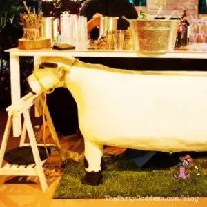 7 Into The Woods Themed Halloween Party Ideas! Ready for Halloween? The Party Goddess, LA's best full service event planner, has ridiculously fab Halloween party ideas inspired from the Disney movie! Check it out at https://thepartygoddess.com/7-into-the-woods-themed-halloween-party-ideas #halloweenparty #halloween #intothewoods @maiasphoto @Disney - cow under bar image