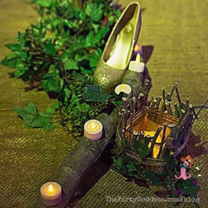 Ready for #Halloween? Let The Party Goddess show you how to make an Into The Woods themed party ridiculously fabulous! Check it out at https://thepartygoddess.com/halloween-party-into-the-woods @maiasphoto #IntoTheWoods #HalloweenParty - shoe and candle image