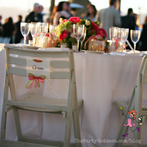 Pop The Champagne! It's Engagement Season! Here comes the bride! The Party Goddess, LA's best full service wedding planner, celebrates engagement season with a look at a gorgeous beach wedding! Check it out at https://thepartygoddess.com/pop-champagne-engagement-season #thebecker #eventplanner #eventprofs #weddings - wedding head table image