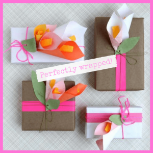 presents wrapped with diy paper calla lillies on top