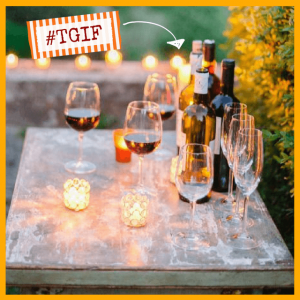 outdoor table with cadles and wine