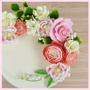 Colorful Spring Sweets & Artisan Confections! - Global Sugar flowers on a white cake