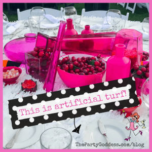 Spring Centerpieces Beyond Floral Arrangements! - pink bottles and cherries as centerpiece on white table