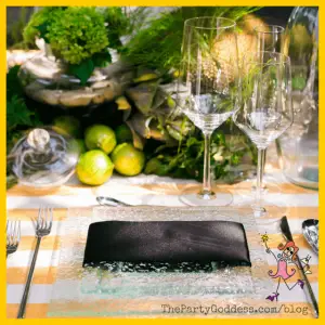Spring Centerpieces Beyond Floral Arrangements! - fruit centerpiece on yellow and white striped tablecloth