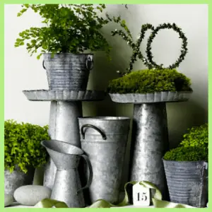 Spring Centerpieces Beyond Floral Arrangements! - moss in tiered galvanized pails
