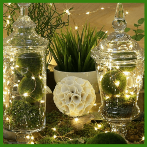 Spring Centerpieces Beyond Floral Arrangements! - glass containers filled with copper string lights and moss