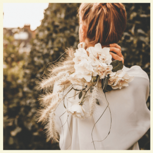 2018 Wedding Trend Predictions From The Experts - woman holding a bouquet over her shoulder