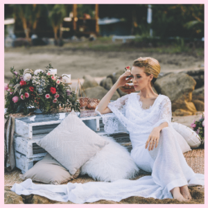 2018 Wedding Trend Predictions From The Experts - casual image of bride on beach with pillows