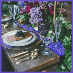 Push For Purple: 16 Ultra Violet Wedding Styles - dark wood table with jewel toned table decor