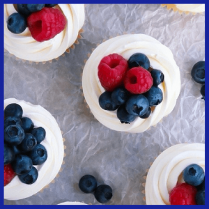 Picnics, BBQ & Boozy Menus For Memorial Day! - cupcakes topped with white frosting, raspberries and blueberries