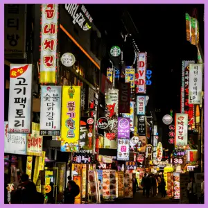 15 Best Trip Planning Hacks To Help You Save! - colorful business signs at night in an Asian country