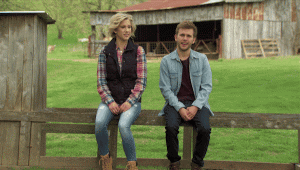 15 Best Trip Planning Hacks To Help You Save! - 2 people sitting on a fence shooing away bugs