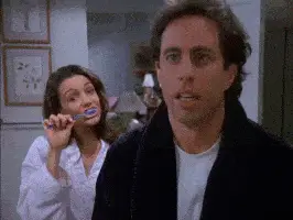 Modern Love: Learning To Love Yourself! - Jerry Seinfeld and lady brushing her teeth behind him