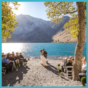 How Millennials Reinvented Wedding Traditions! - bride and groom kissing at a lakefront wedding ceremony