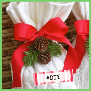 Gift Wrapping: The Presentation Of Presents! - gift wrapped in a recycled white sweater sleeve with big red bow and pinecones