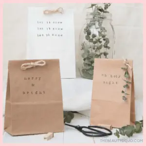 Gift Wrapping: The Presentation Of Presents! - gift wrapped in a lunch bag with a stamped saying and sprig of mistletoe