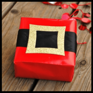 Gift Wrapping: The Presentation Of Presents! - gift wrapped in red paper with a black band and gold buckle