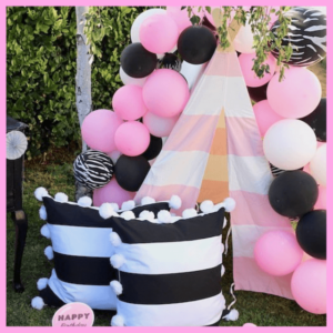 We Made The List Of Top Party Planning Blogs! - black and white pillows set up next to a pink and white tent covered in balloons
