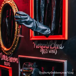 Halloween: The Nutcracker And The Four Realms! - hand coming out of the wall serving a glass of red wine